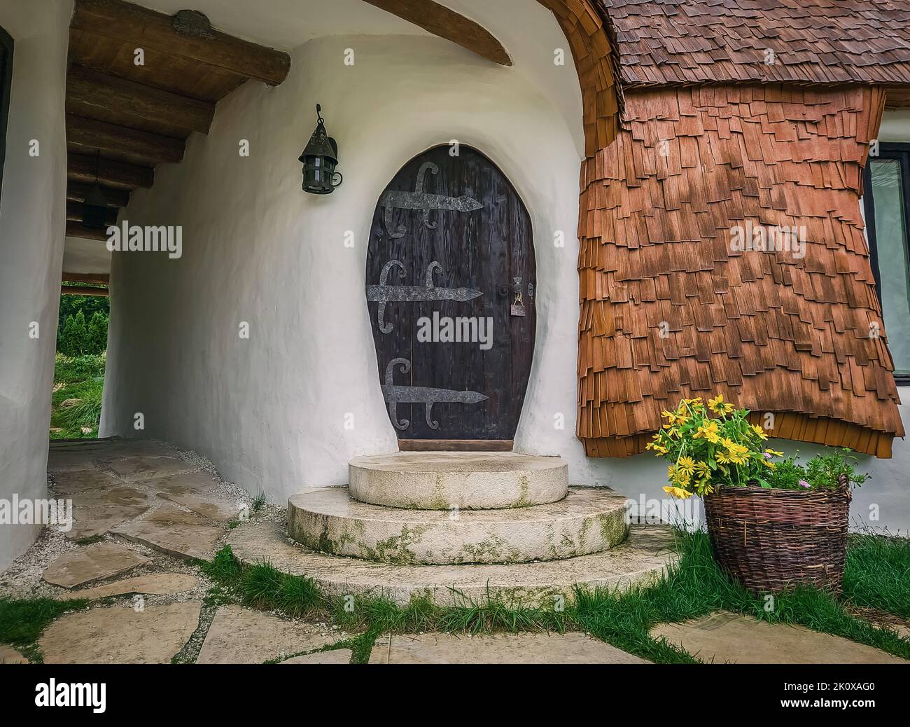 The Clay Castle from the Valley of Fairies, a touristic complex in Transylvania, Romania. Closeup view to a tiny entrance door, fantasy hobbit house f Stock Photo