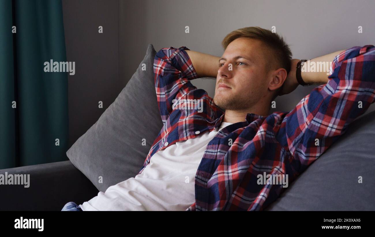 A young man resting on the couch Stock Photo