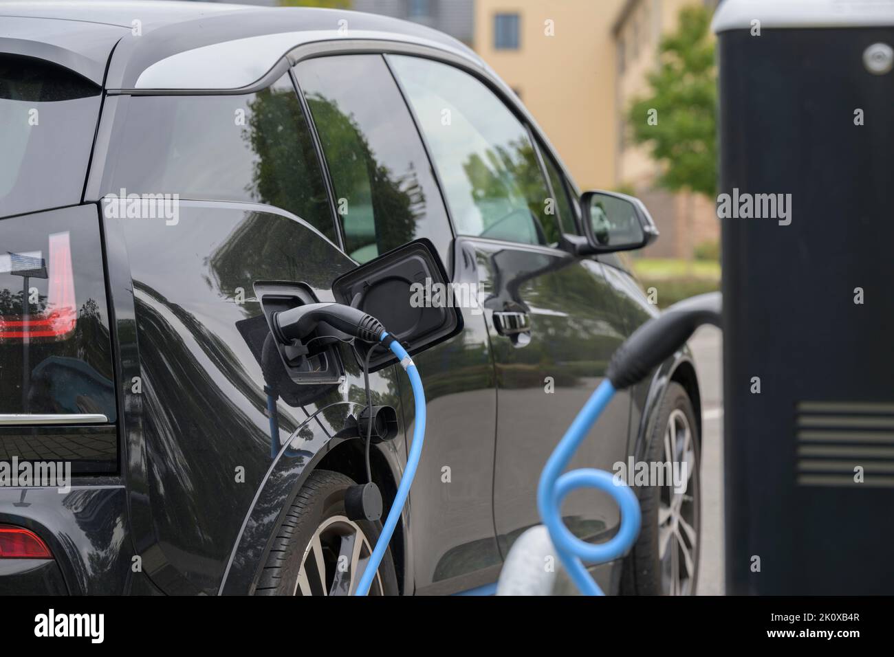 An electric car during the charging process Stock Photo
