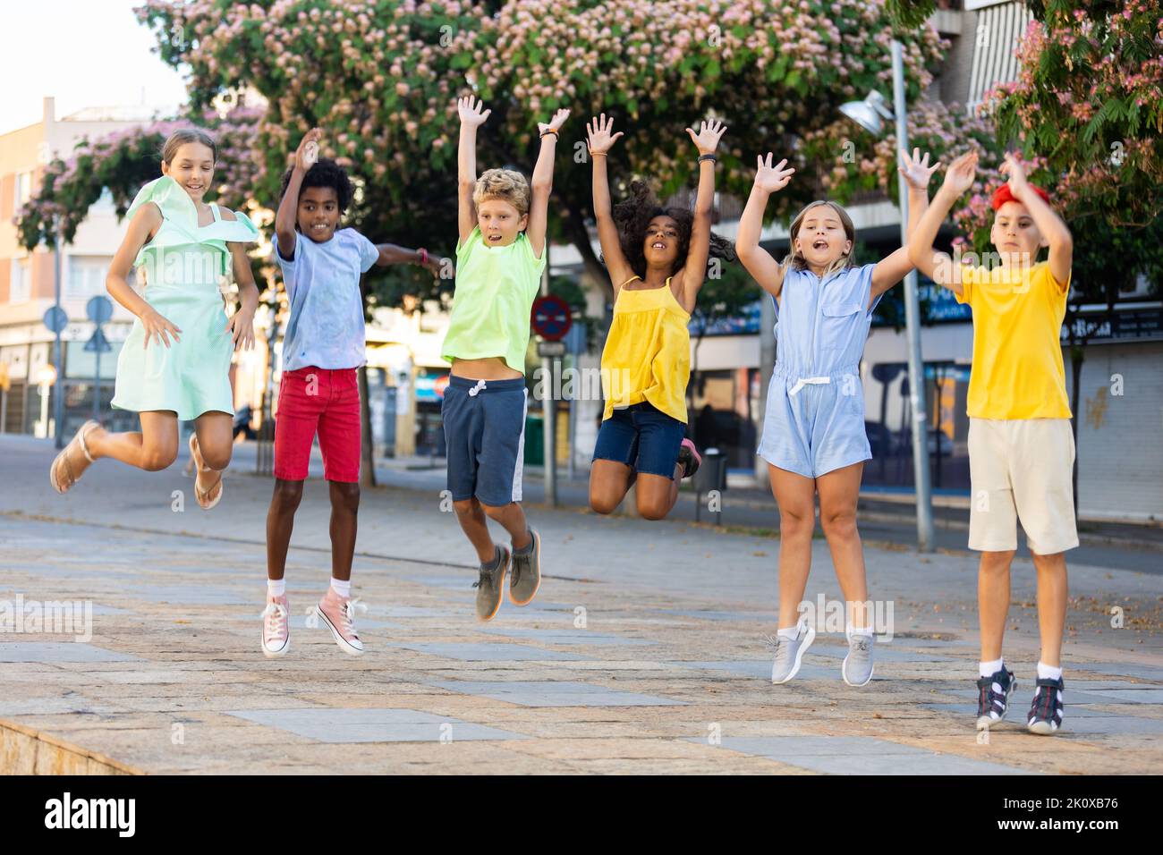 Happy multiracial boys and girls jumping outdoors Stock Photo - Alamy