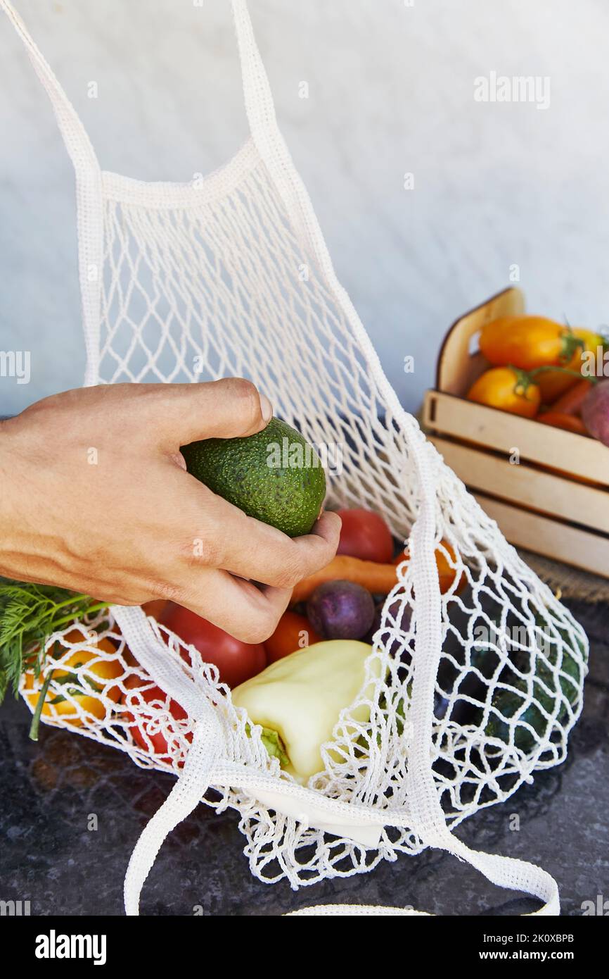 Fresh Avocado in eco bag for fruits and vegetables Stock Photo - Alamy