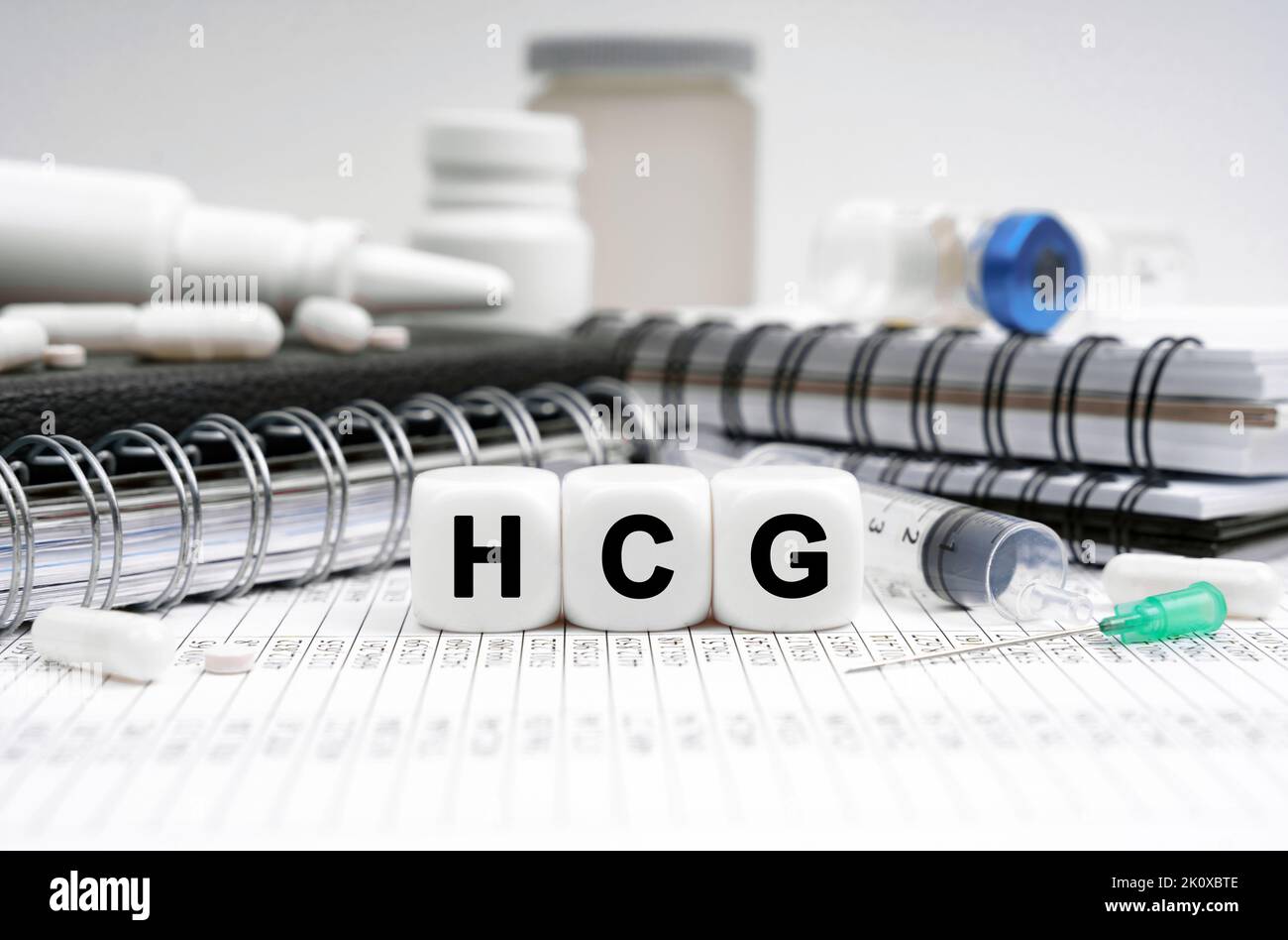 Medicine concept. On the table are diaries, medicines and cubes with the inscription - HCG Stock Photo