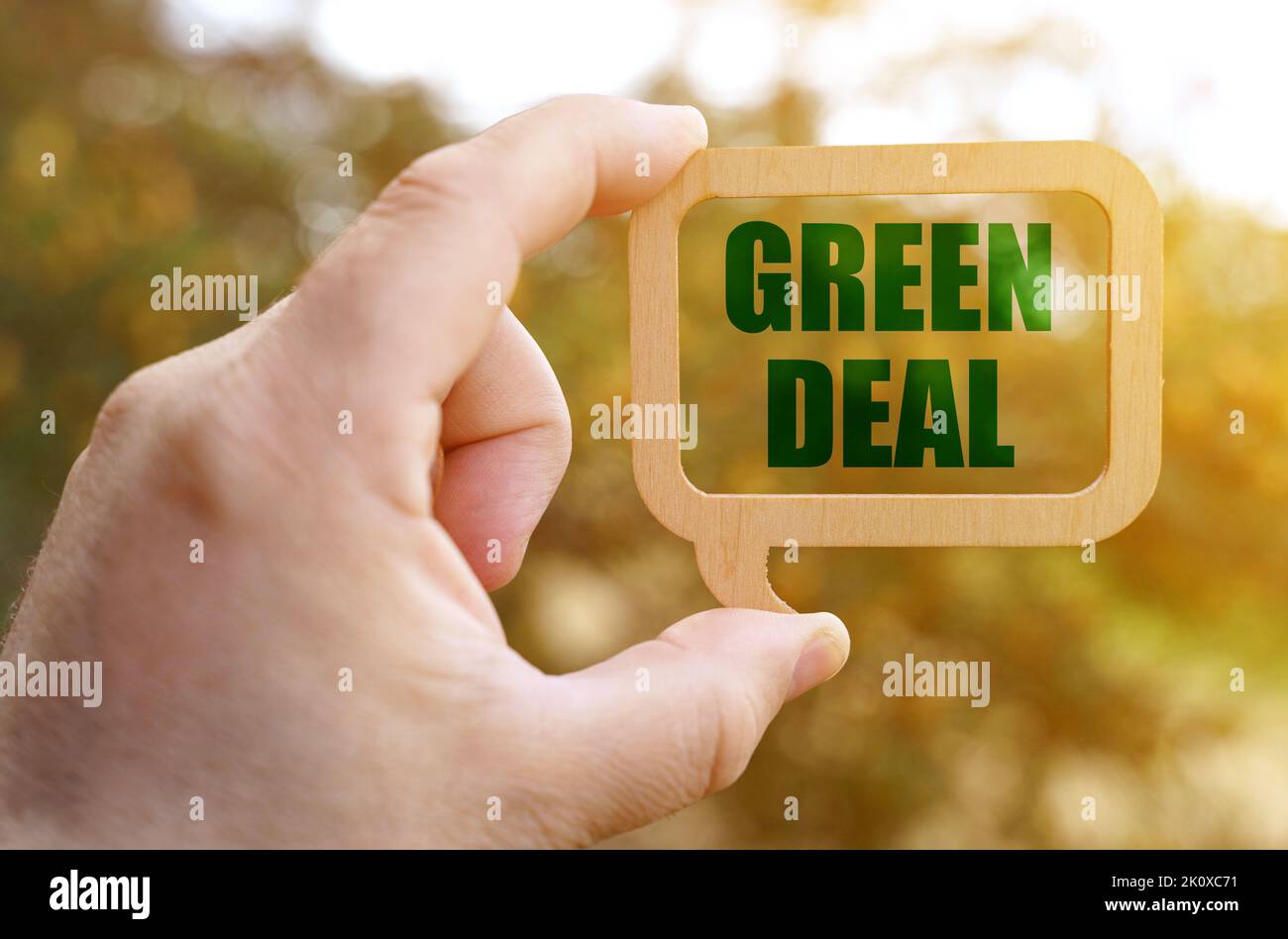 Ecology concept. A man holds a sign inside which the inscription - Green Deal Stock Photo