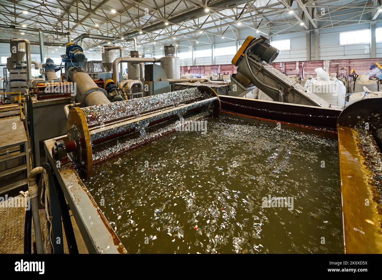 Automatic shredded plastic washing machine. Washing in a bath of water