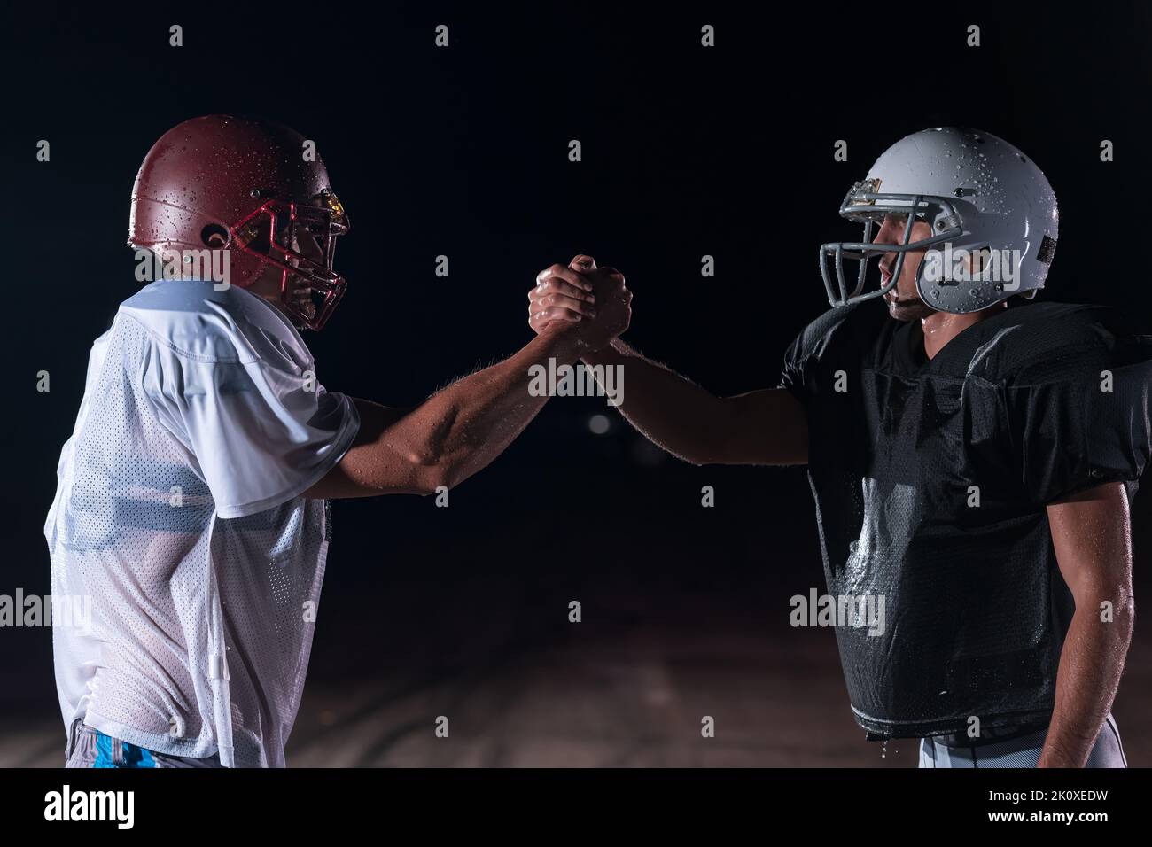 two american football players face to face in silhouette shadow on