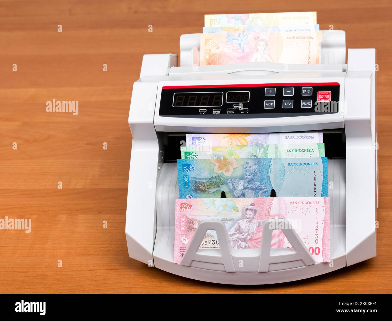 Indonesian money - Rupiah in a counting machine Stock Photo