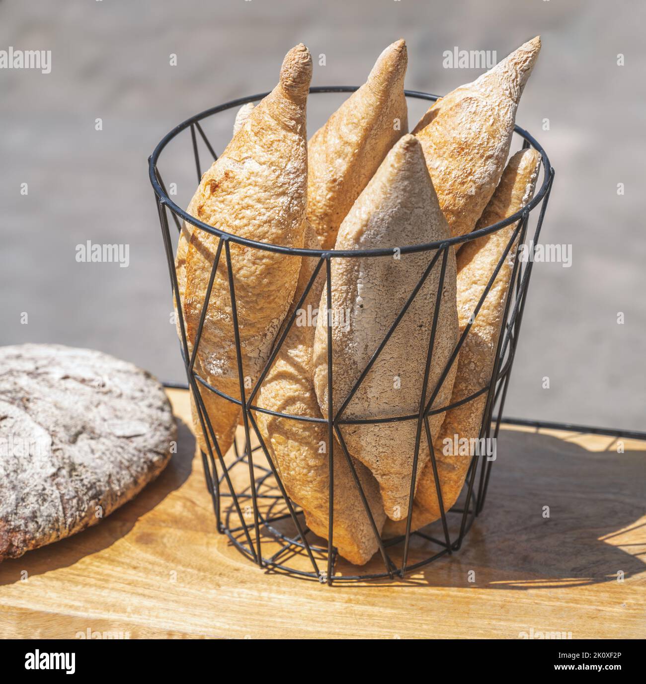 Breadbasket with crispy white bread on the table of a restaurant Stock Photo