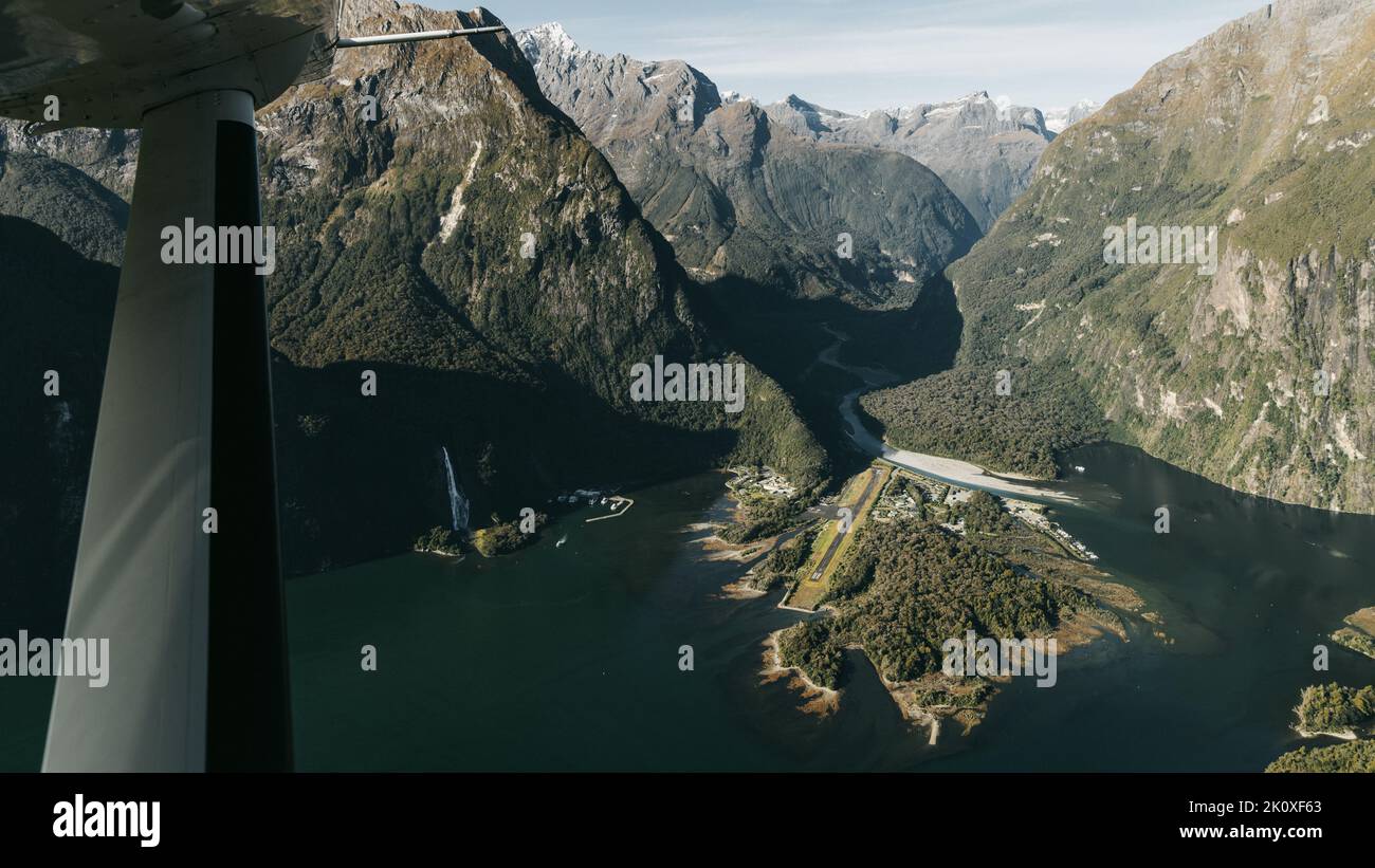 New Zealand. Milford Sound (Piopiotahi) from above - the head of the fiord with wharf and Milford Sound Airport. Stock Photo