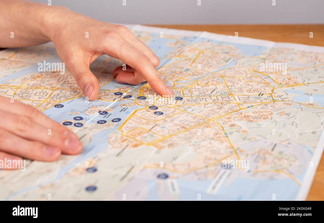 Hands on map. Woman studying travel itinerary. Journey planning. Female ...