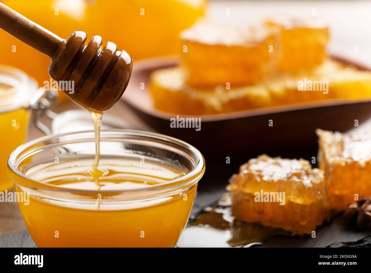Honey on wooden honey-dipper closeup food background Stock Photo