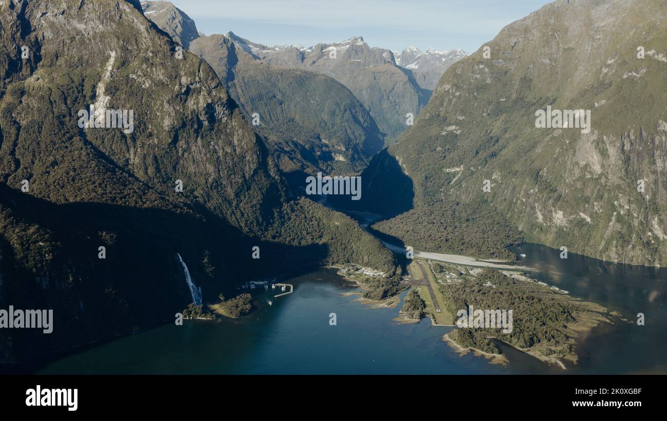 New Zealand. Milford Sound (Piopiotahi) from above - the head of the fiord with wharf and Milford Sound Airport. Stock Photo