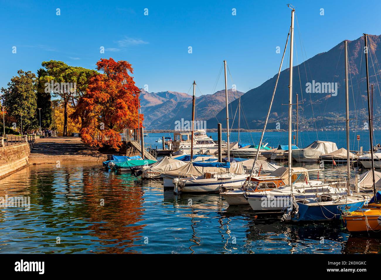 View of boats and yachts on Lake Maggiore in autumn in Locarno, Switzerland. Stock Photo