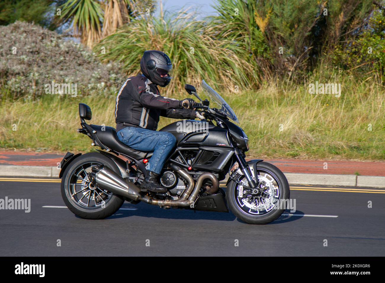 2014 DUCATI DIAVEL STRADA 1198cc; Ducati's liquid-cooled, 1,198cc Testastretta 11˚ L-twin motorcycle with V-Twin Testastretta engine travelling on the seafront promenade in Southport, Uk Stock Photo
