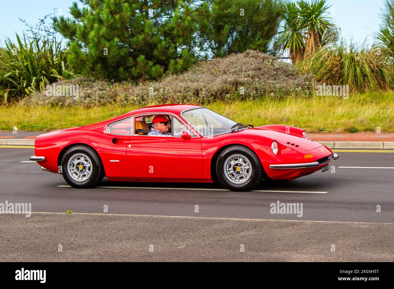 1973 70s seventies red  FERRARI DINO 2416 cc V6 engine petrol roadster; on display at the Southport Classic car and Speed event on the seafront promenade. Stock Photo