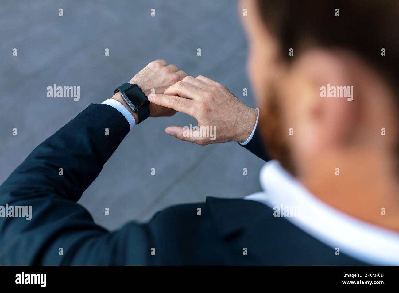 Guy Check Young caucasian guy with beard in suit checks time on smartwatch with ...