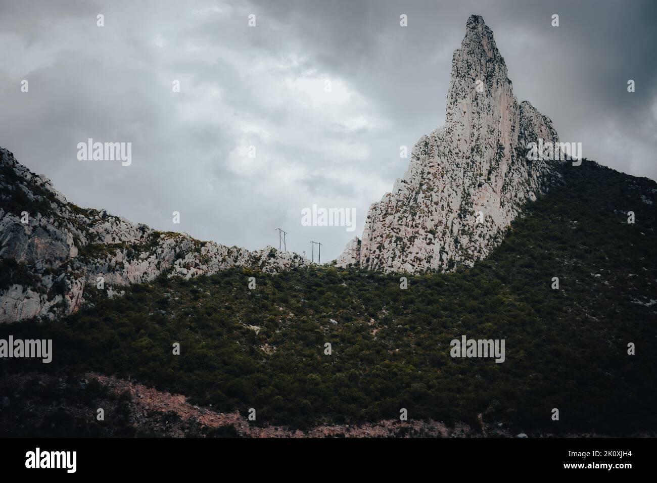 A beautiful shot of a mountain at La Huasteca national park against a gray cloudy sky Stock Photo
