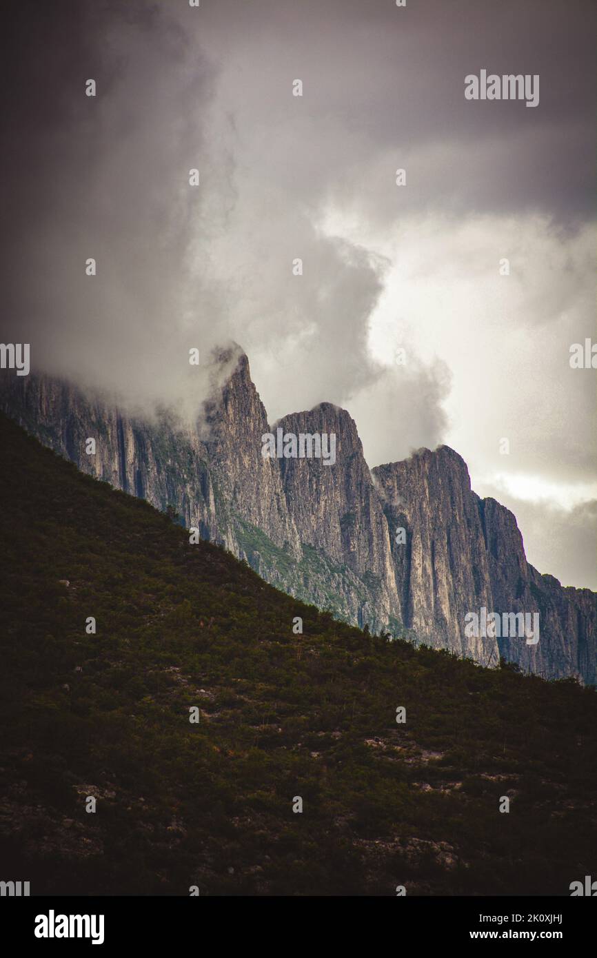 A beautiful shot of a cloudscape covering the mountains at La Huasteca national park Stock Photo