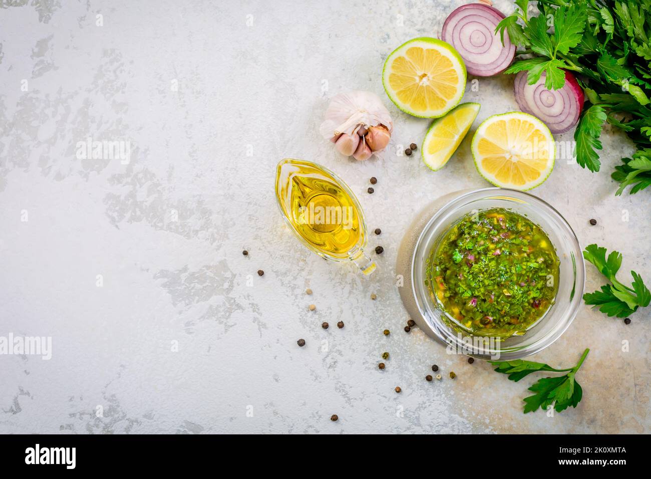 Chimichurri - homemade fresh Latin American sauce made from various herbs, garlic and red wine vinegar. Cooking ingredient or table condiment Stock Photo
