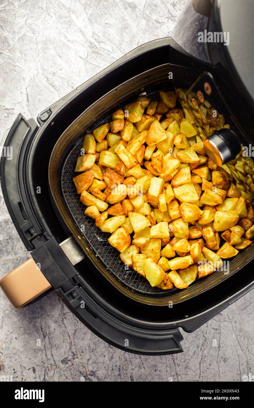 Homemade baked potatoes made in air fryer, healthy way to cook deep-fried food Stock Photo