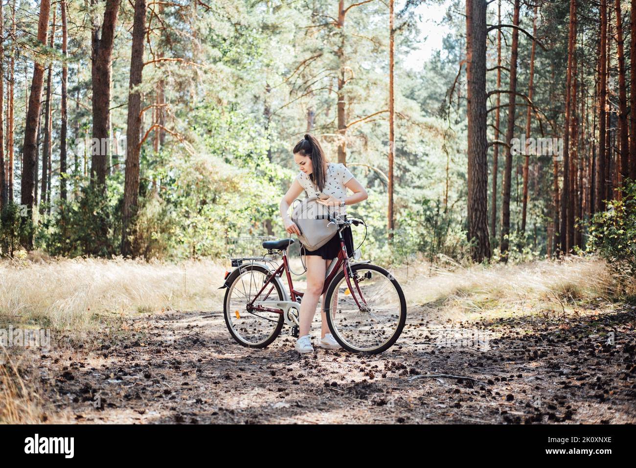 How to pack for bike ride, Bicycle Touring Checklist. Young woman with ...