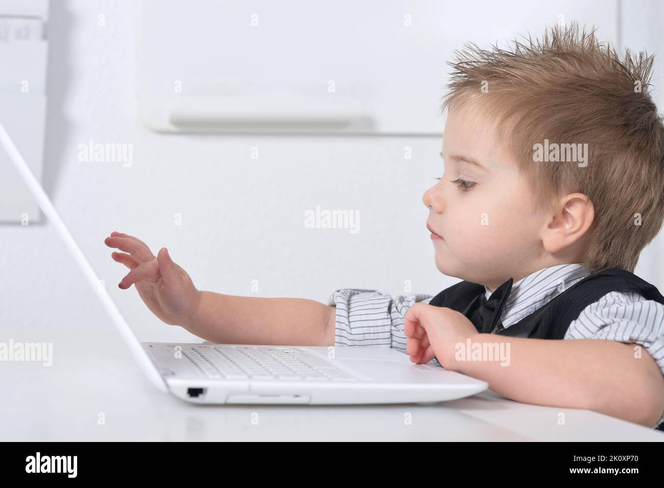 little-handsome-boy-sits-with-a-computer-stock-photo-alamy