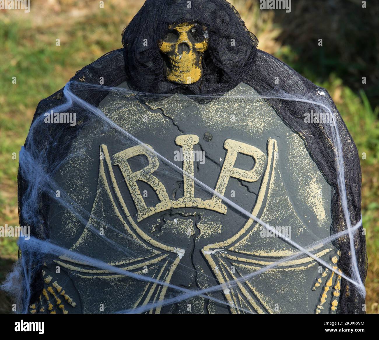 Skull on a tombstone. horror mask. Undead Zombie Face Mask. Close up. Stock Photo