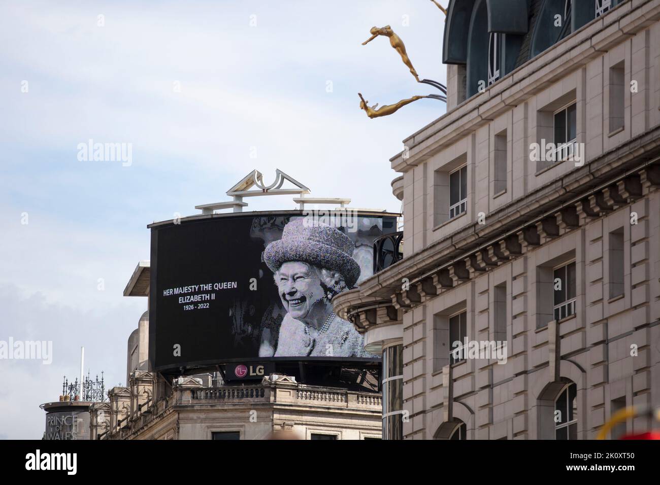 LONDON, UK - September 2022: A portrait of Queen Elizabeth II is shown on a large screen in Piccadilly Circus after her death Stock Photo