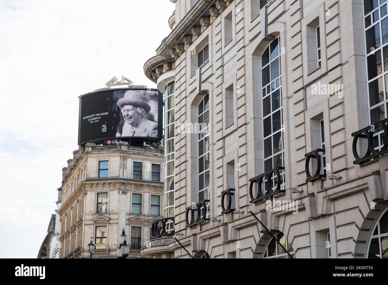 LONDON, UK - September 2022: A portrait of Queen Elizabeth II is shown on a large screen in Piccadilly Circus after her death Stock Photo