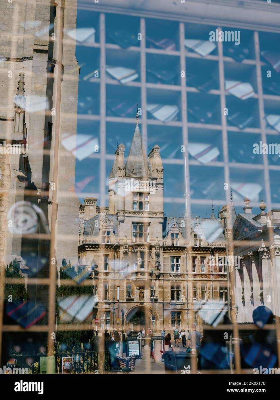 University of Cambridge ties on display in an outfitter shop window in with the historic architecture reflected, Cambridge Cambridgeshire England UK Stock Photo