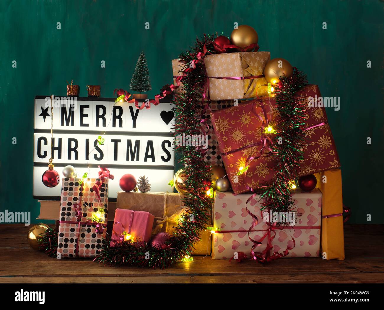 Christmas gifts, gift wrap,decoration,lights and display with caption Merry Christmas Stock Photo