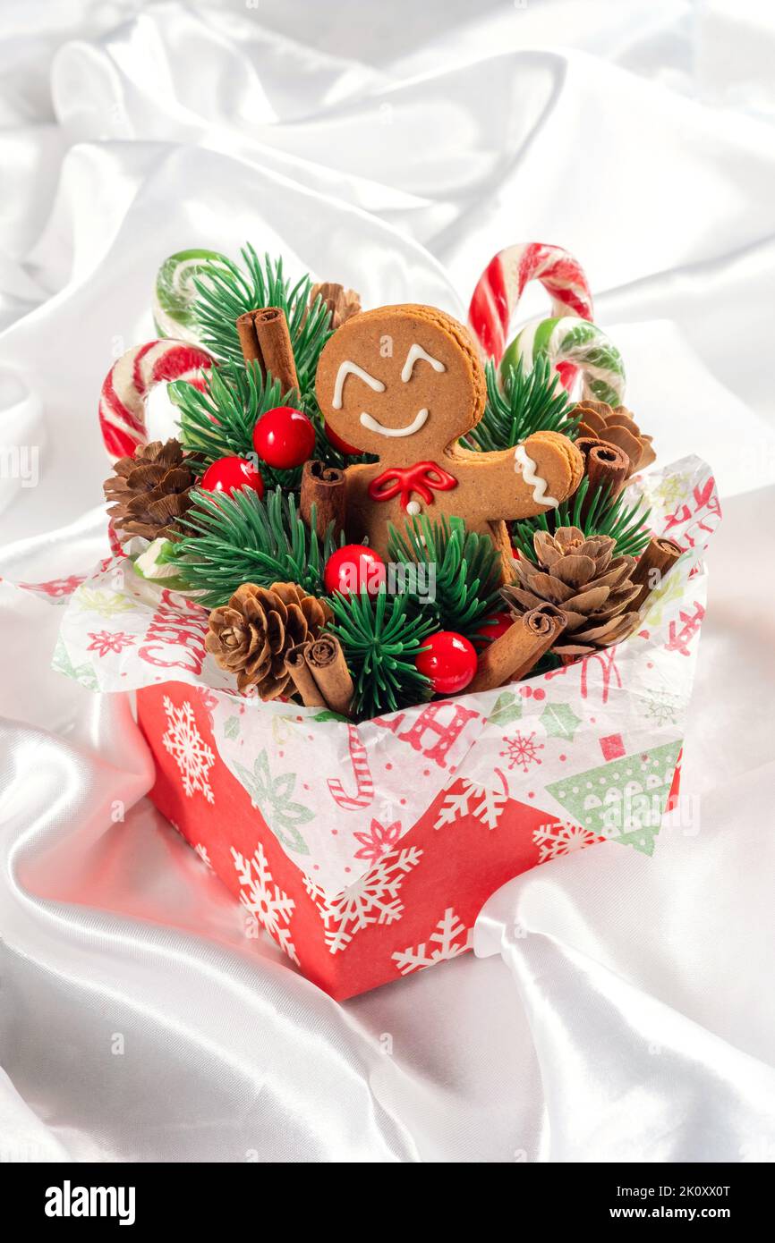 Christmas Decorations with Gingerbread man cookie and Gift Box. Stock Photo