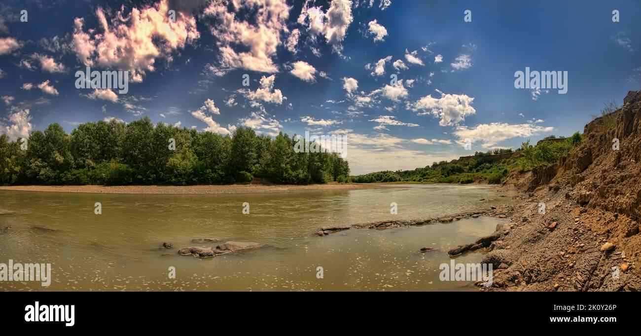 Potamology. A river in the foothills with high clay banks. Example of riverwash (fluvial erosion), alluvial deposits Stock Photo