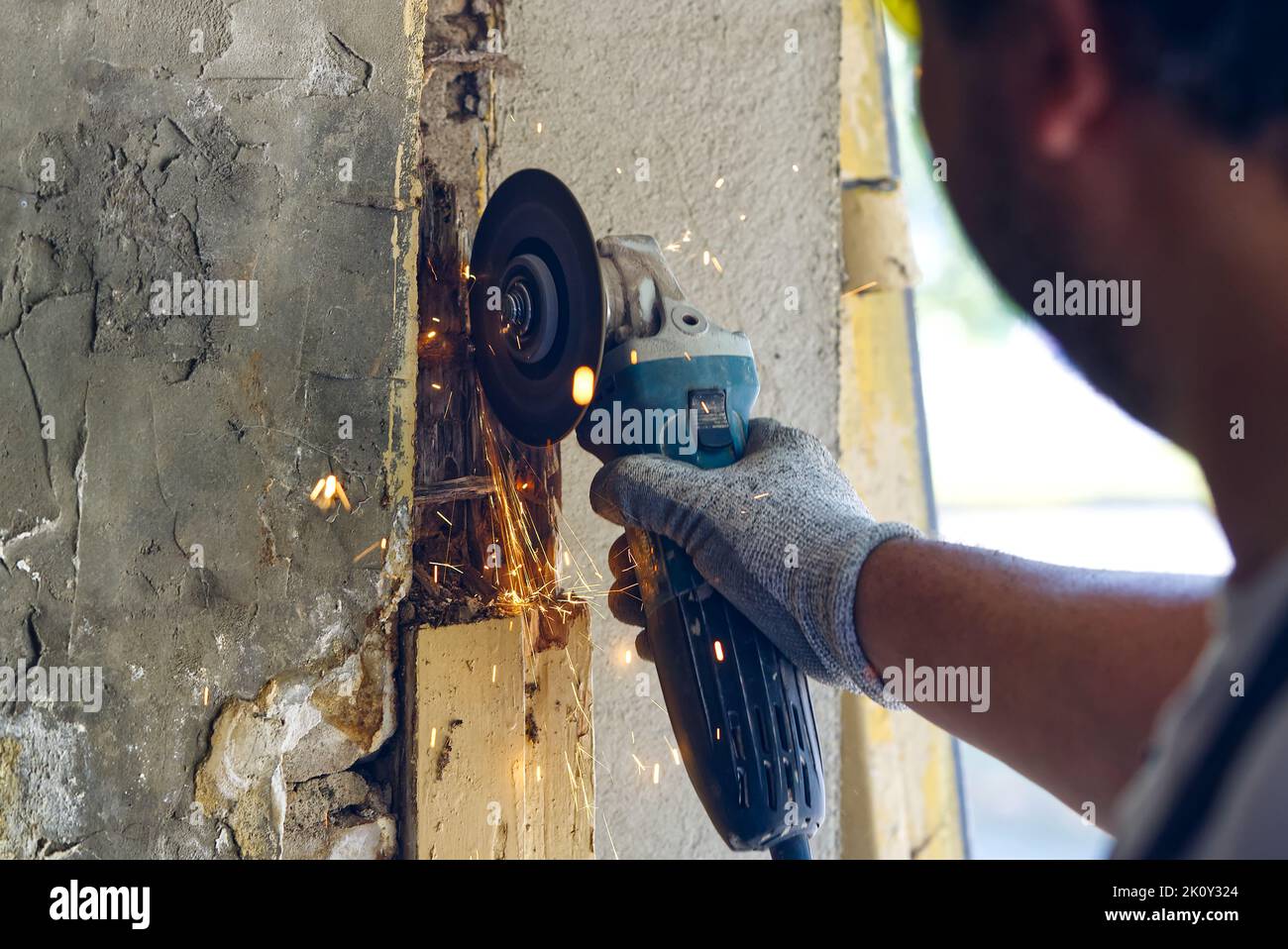 young master repairing old garage doors. handyman repairing a rotten ...