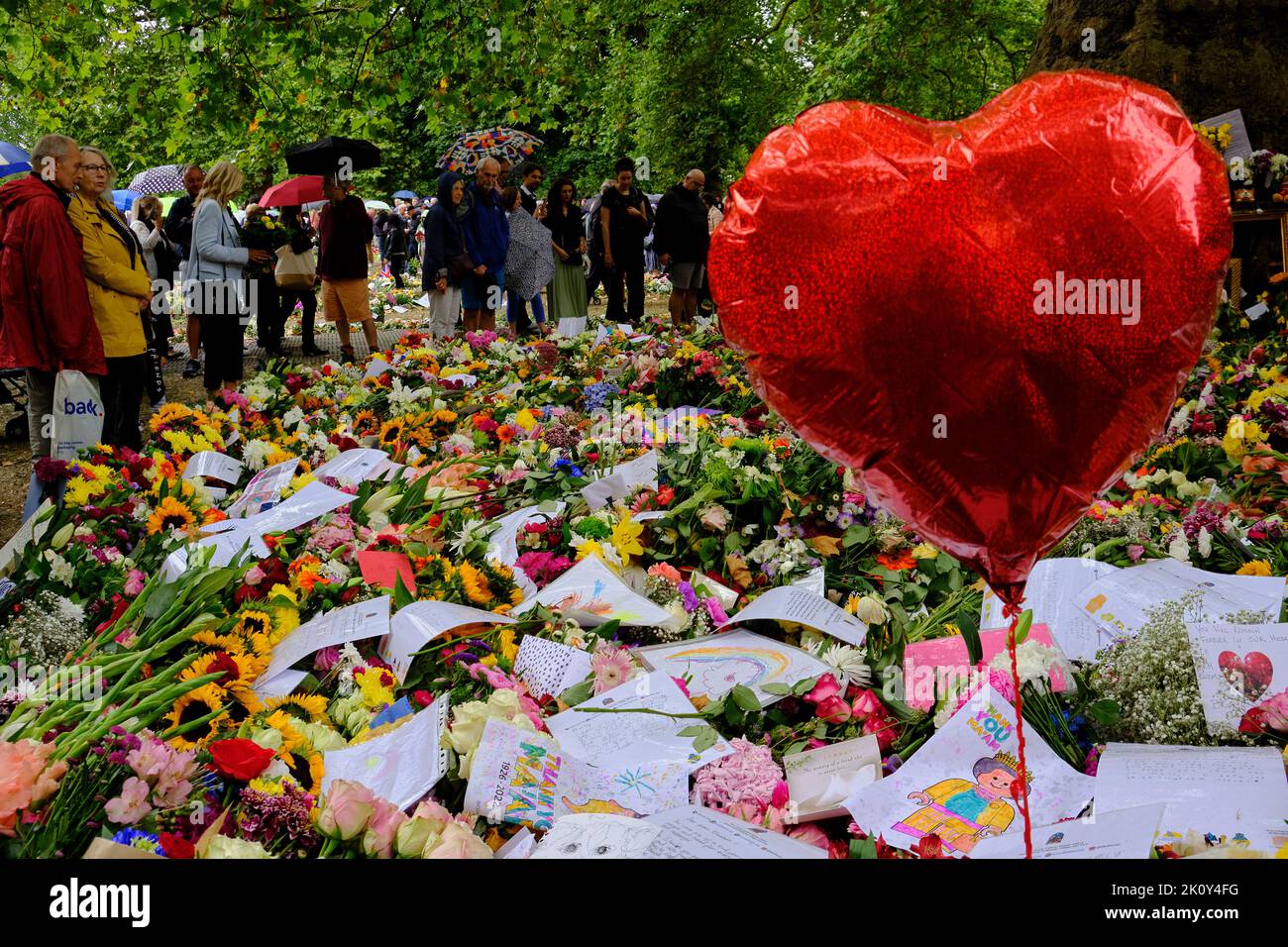 floral tributes to the late Queen festoon the grounds of Green park in London Stock Photo
