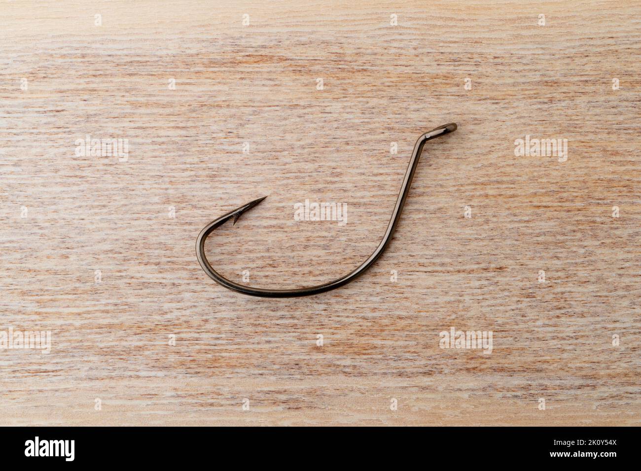 Top view of a new drop shot fish hook on a wood surface. Stock Photo