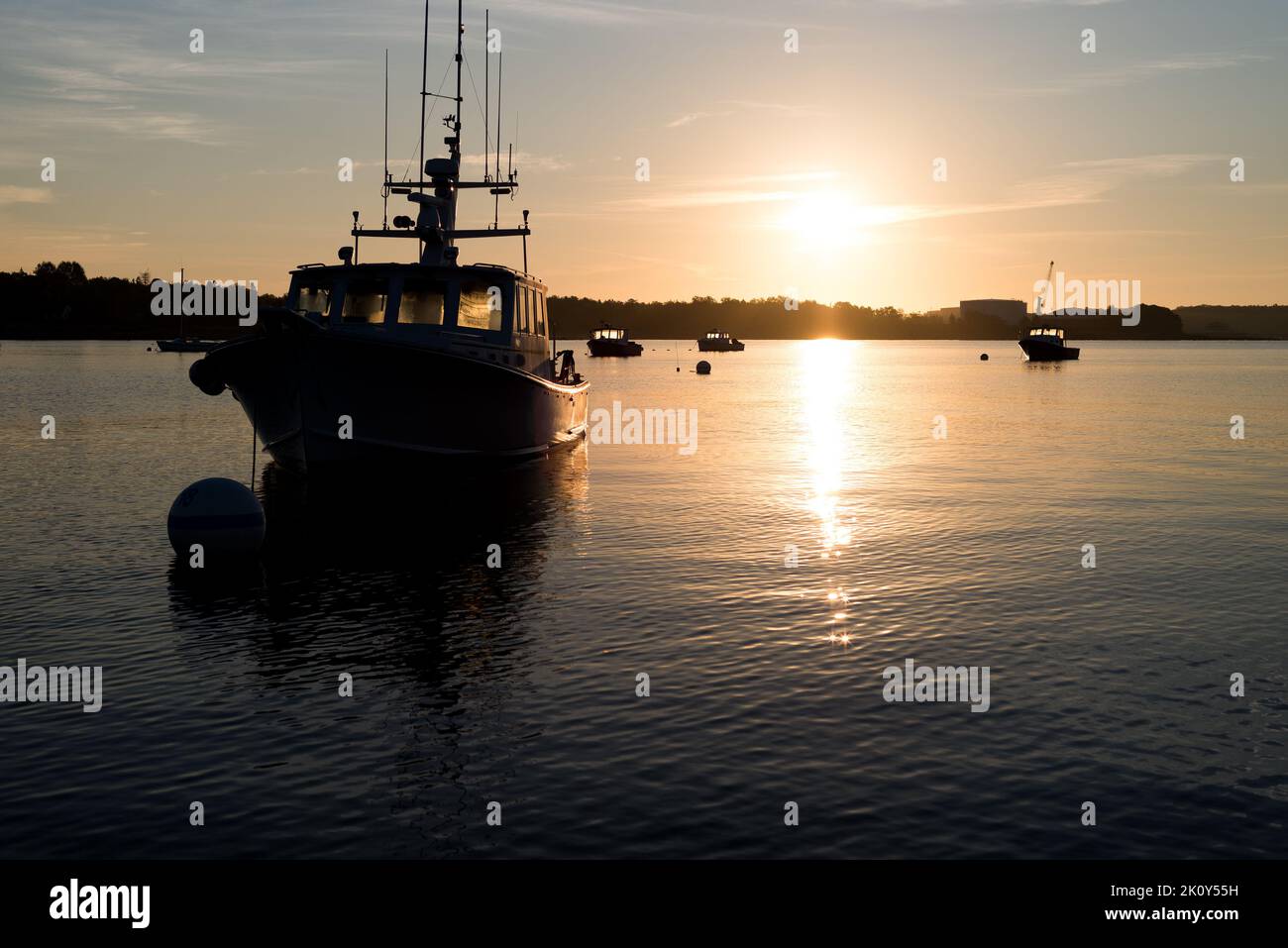 Moored boats at dawn light in Maine. Stock Photo