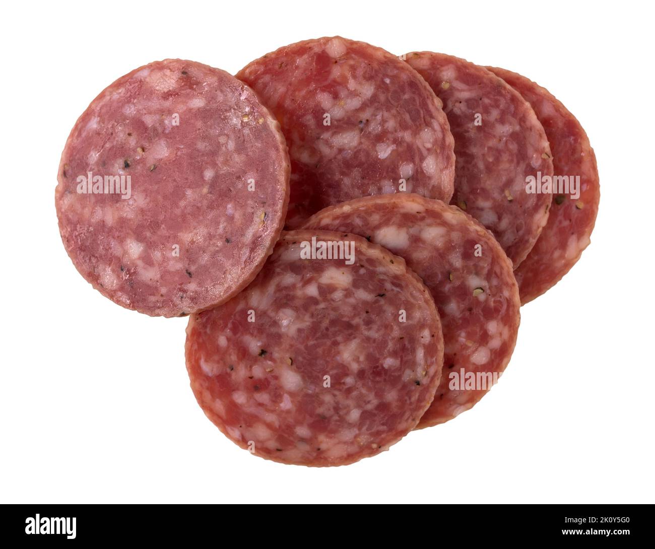 Top view of several slices of dry salami isolated on a white background. Stock Photo