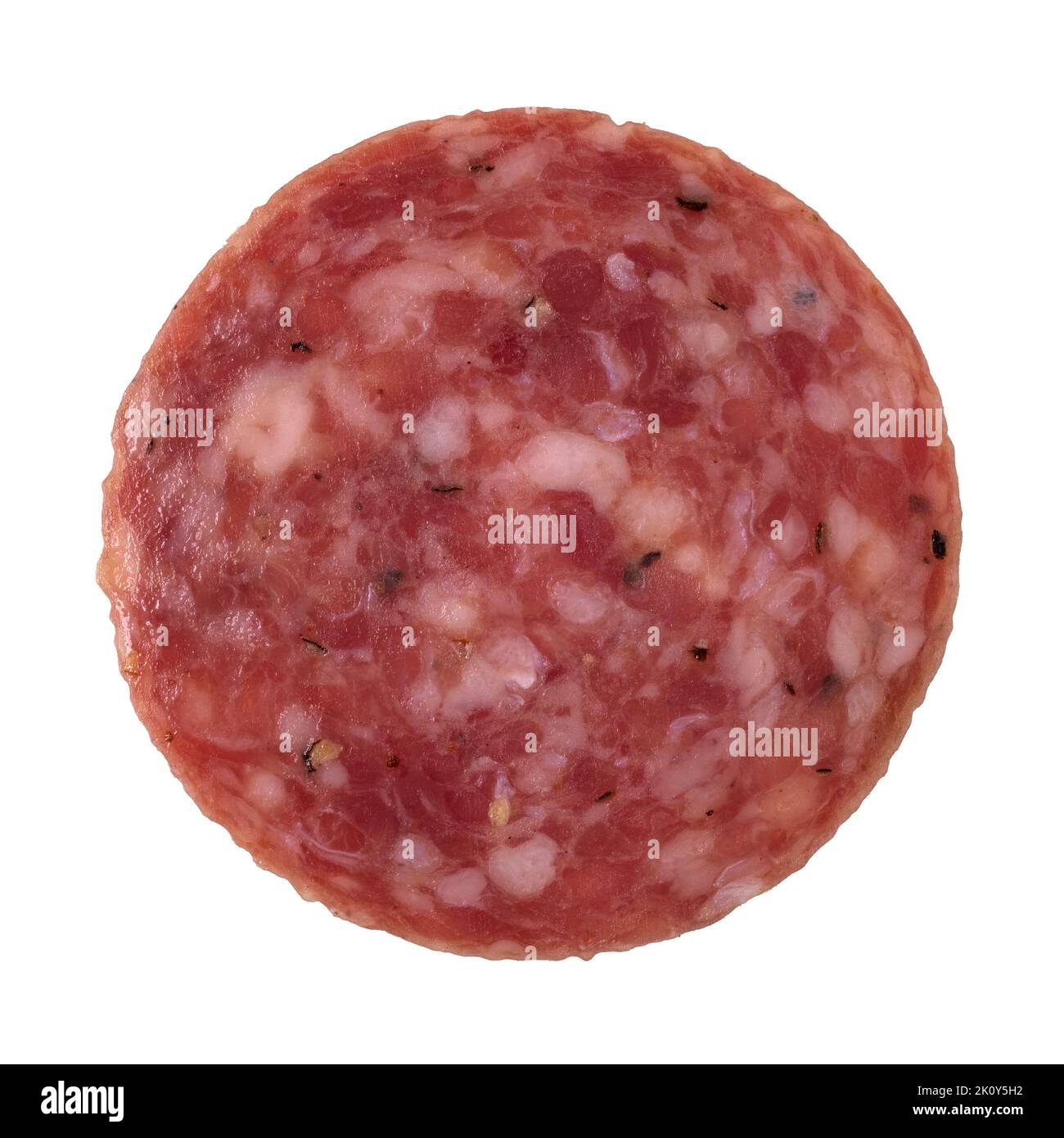 Top view of a single slice of dry salami isolated on a white background. Stock Photo