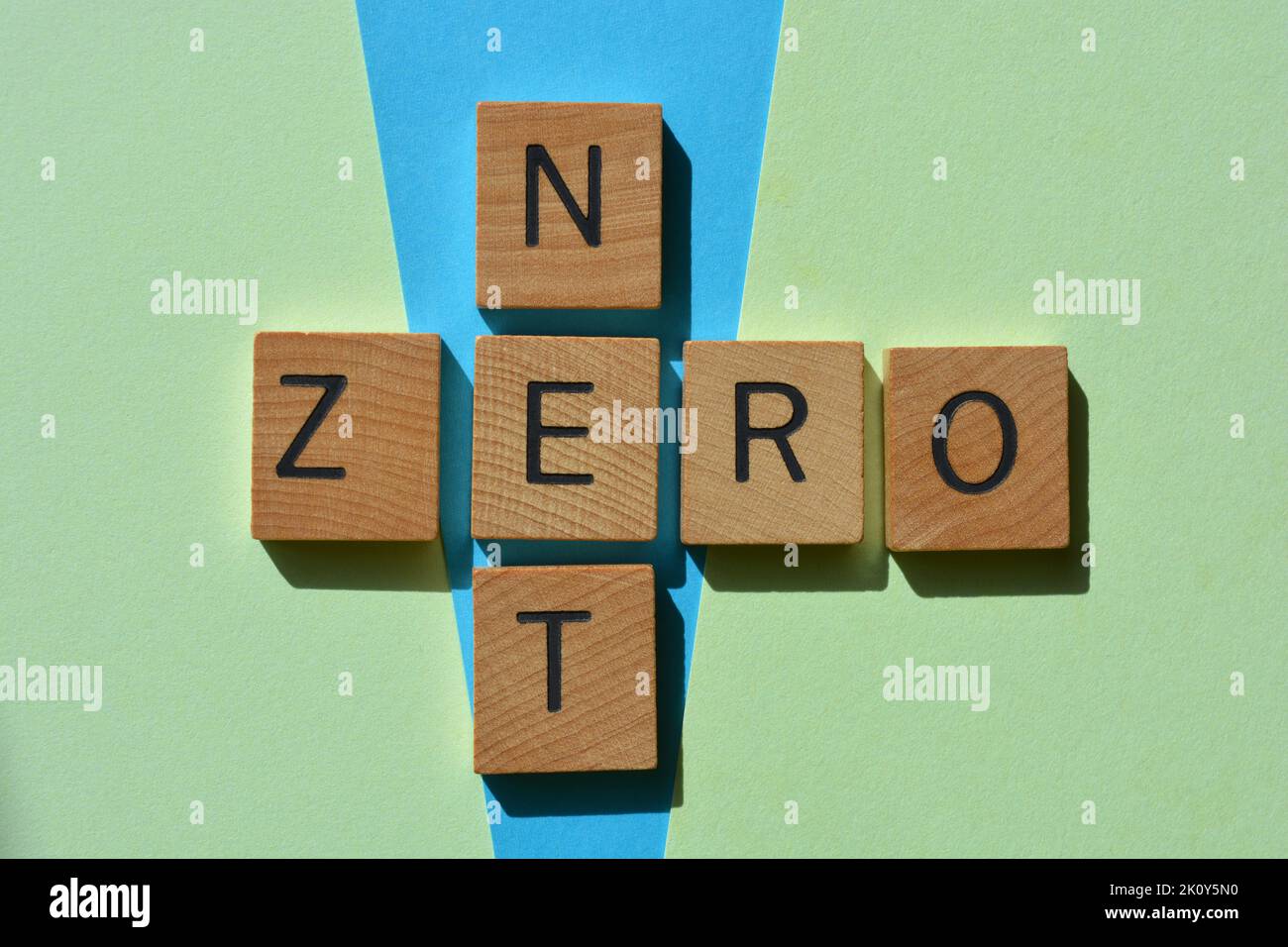 Net Zero, words in wooden alphabet letters in crossword form on blue and green background Stock Photo