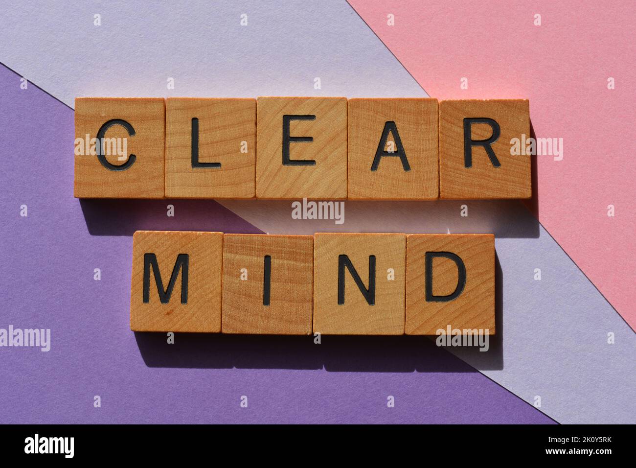 Clear Mind, words in wooden alphabet letters isolated on pink and purple background Stock Photo