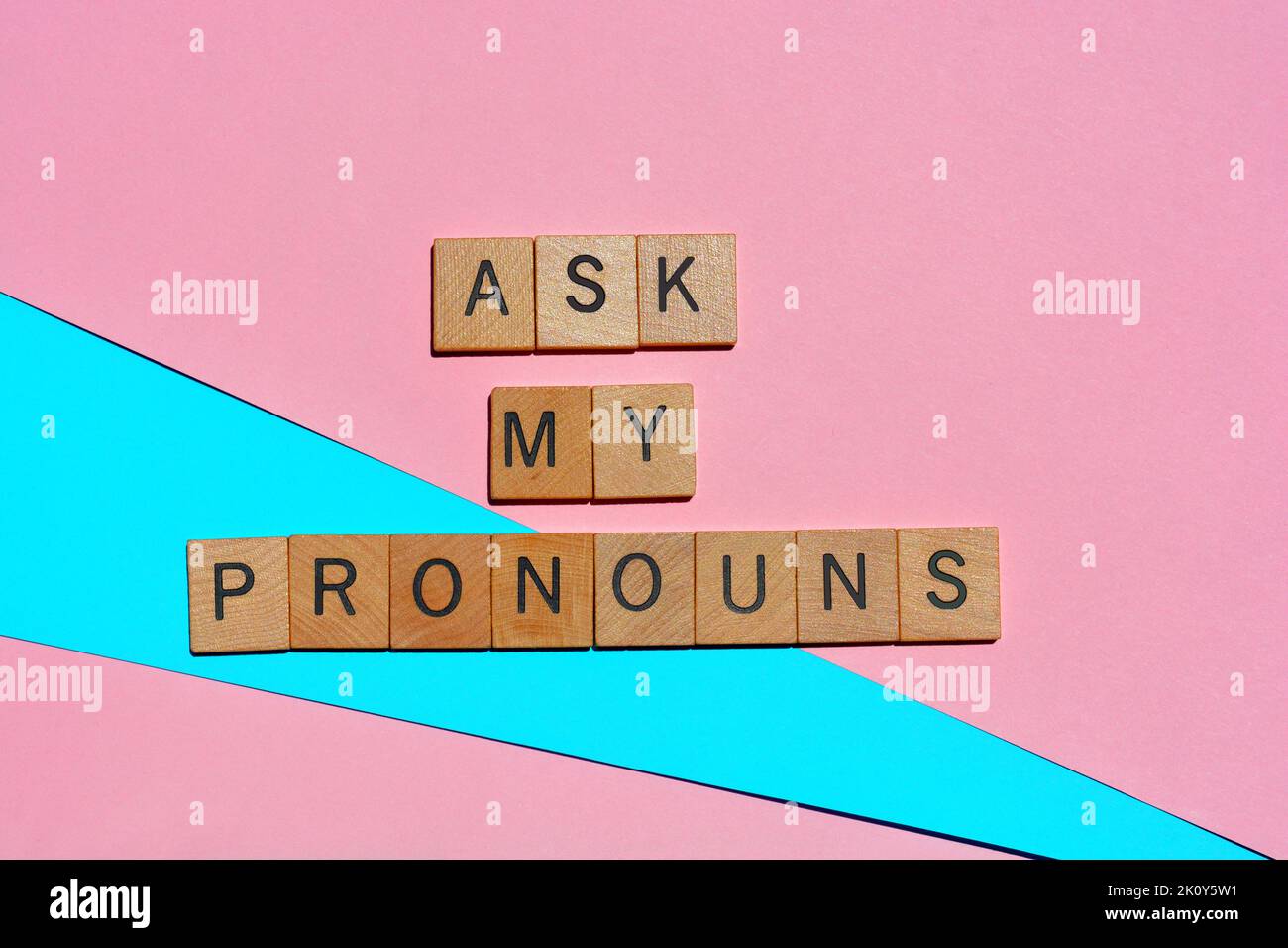 Ask My Pronouns, words in wooden alphabet letters isolated on pink and blue background Stock Photo