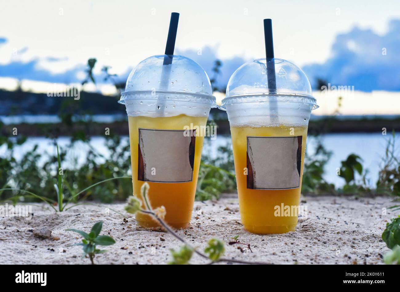 Two plastic cups with iced tea take away against sea Stock Photo Alamy