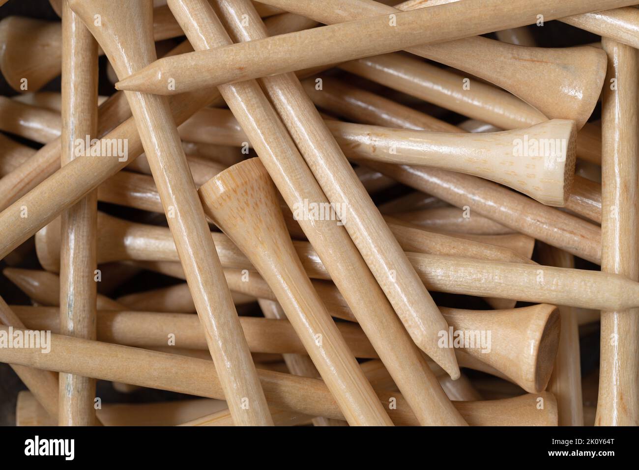 Close view of a group of wood golf tees illuminated with morning light. Stock Photo