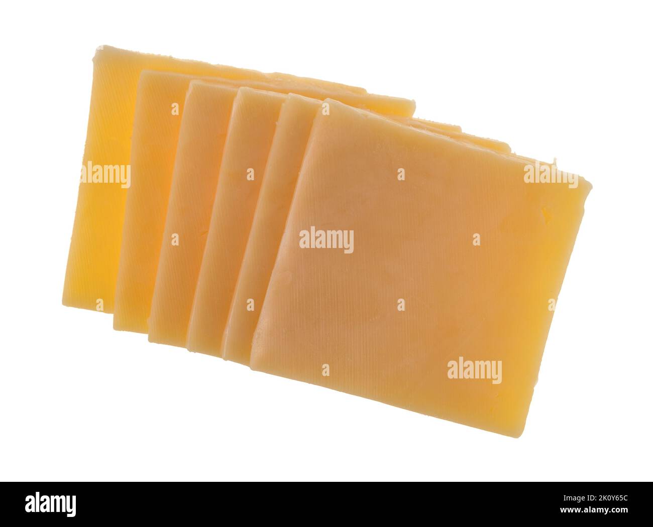 Overhead view of several slices of gouda cheese in a row isolated on a white background. Stock Photo