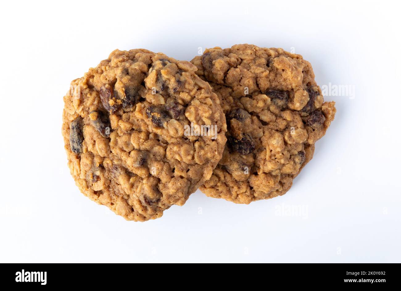 Overhead view of two homemade oatmeal raisin cookies on a white plate. Stock Photo