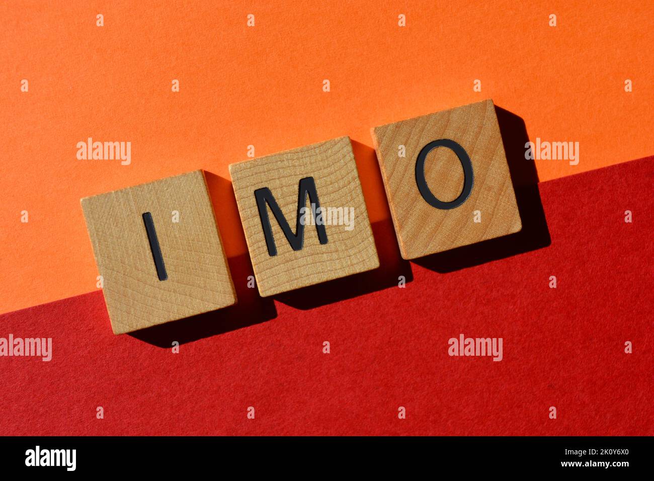 IMO, abbreviation for In My Opinion in wood alphabet letters isolated on background as banner headline Stock Photo