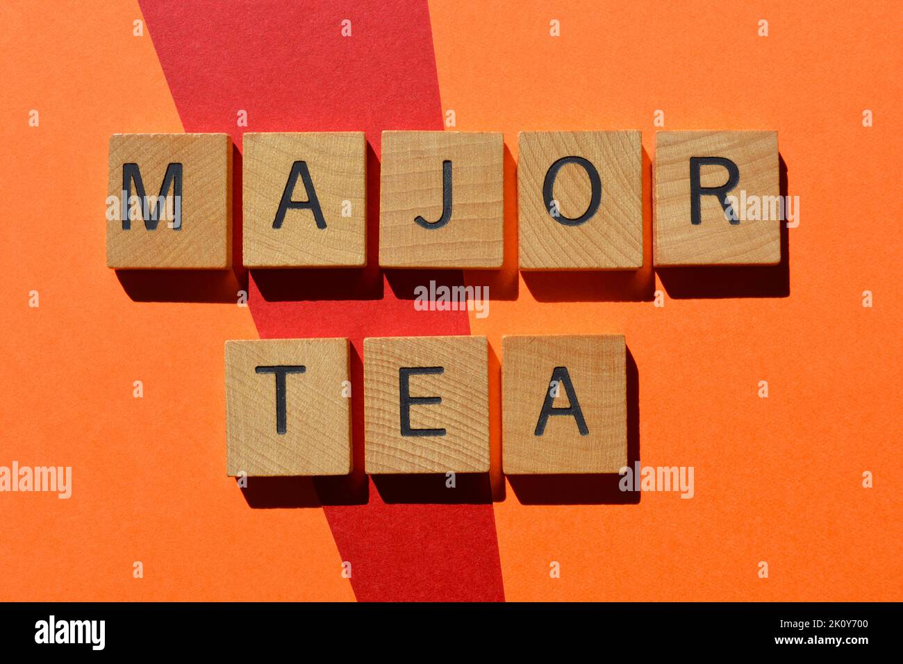 Major Tea, phrase meaning big gossip or scandal, in wooden alphabet letters isolated on background Stock Photo