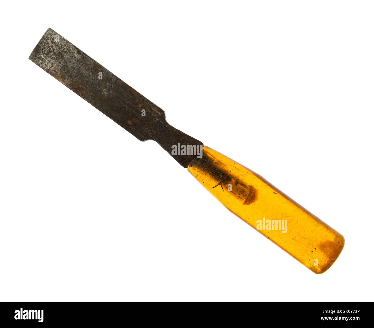Old used and rusted wood chisel with a translucent handle isolated on a white background. Stock Photo