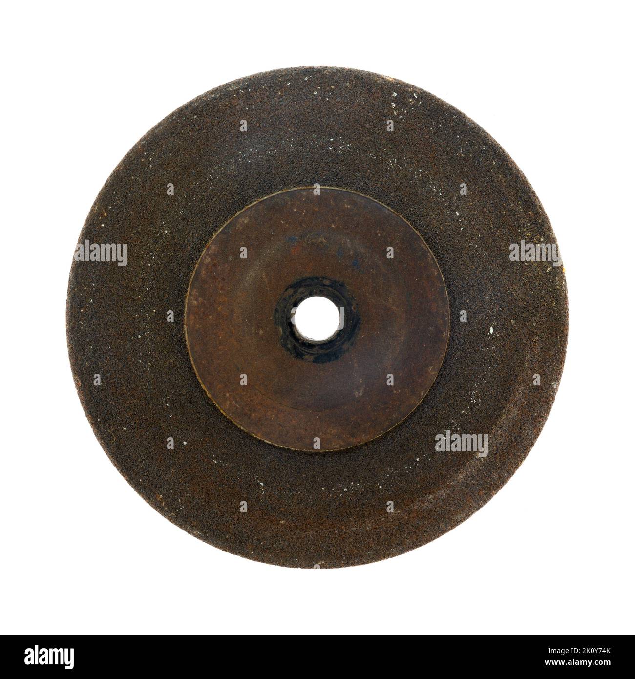 Old worn and used grinding wheel isolated on a white background. Stock Photo