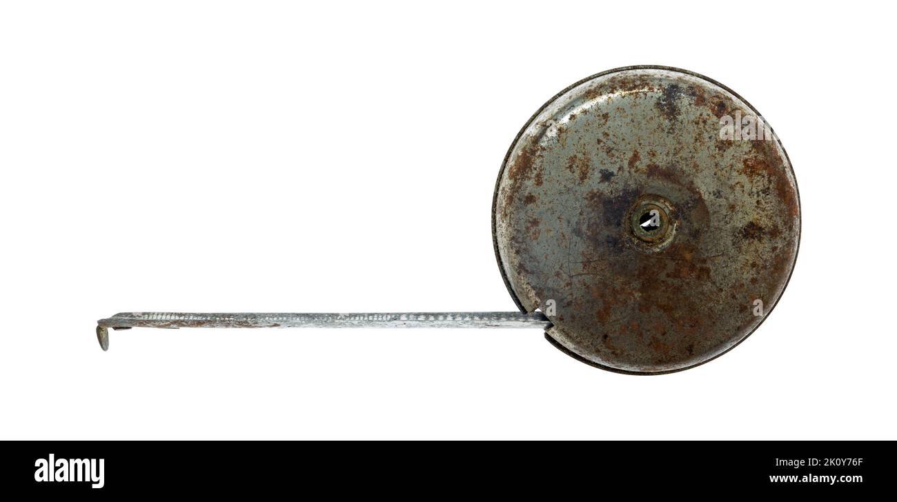Side view of an old tape measure with part of the tape out isolated on a white background. Stock Photo